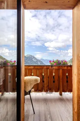 a room with a balcony with a view of the mountains at Zischgalm in Obereggen