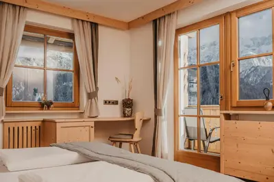 a room with wooden walls and a door at Gutonhof in Selva di Val Gardena