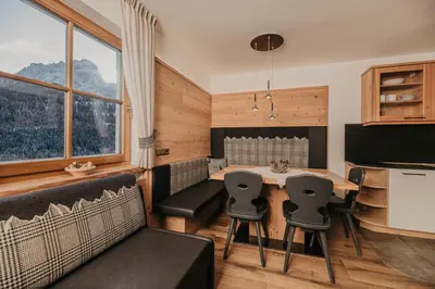 a table with breakfast food and a view of a mountain at Gutonhof in Selva di Val Gardena