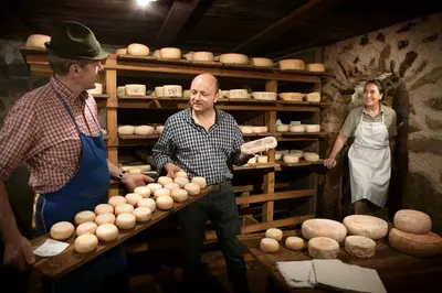 two men and a woman in a bakery with eggs at Terra - The Magic Place Relais & Châteaux in Sarntal