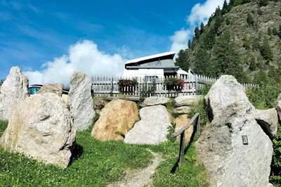 a group of rocks in front of a building at Camping Bergkristall in Moso