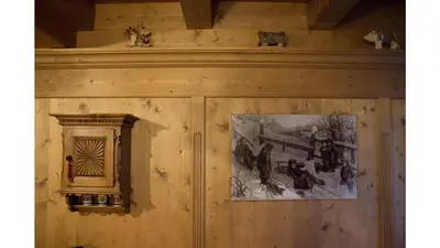 a wall with a picture and a picture on it at Cristallo & Faloria Suite Apartments in Cortina dʼAmpezzo