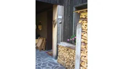 a window of a house with a flower pot on it at Cristallo & Faloria Suite Apartments in Cortina dʼAmpezzo