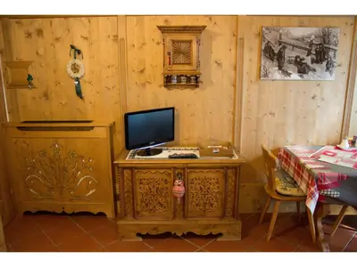 a room with a desk with a computer on it at Cristallo & Faloria Suite Apartments in Cortina dʼAmpezzo