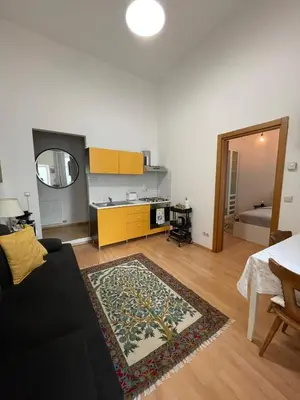 a living room with a couch and a table at Appartamenti Duomos in Merano