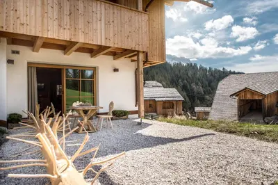 a patio with a table outside of a house at Mountain Chalet Pia in La Valle