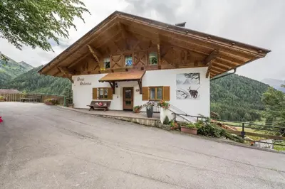 a small house with a gambrel roof at Gasthof Innerwalten in San Leonardo in Passiria