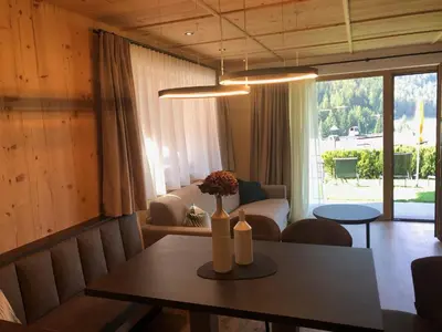 a living room with a table and a couch at Pra Ciarea Apartments in Ortisei