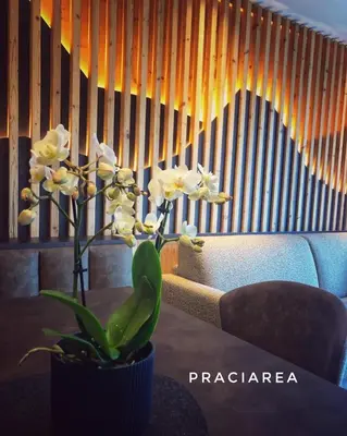 a table with a vase with white flowers on it at Pra Ciarea Apartments in Ortisei