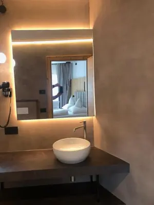 a bathroom with a sink and a mirror at Pra Ciarea Apartments in Ortisei