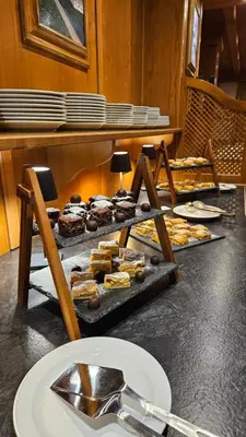 a bunch of different types of pastries on a table at Berghotel zum Zirm in Collalbo