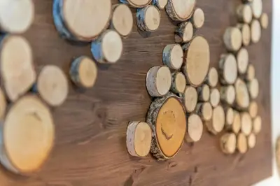 a bunch of wine barrels lined up on a wall at Appartamenti Residence La Roggia in Pozza di Fassa