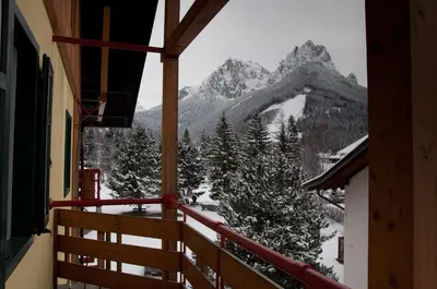a balcony with a view of a snow covered mountain at Appartamenti Residence La Roggia in Pozza di Fassa