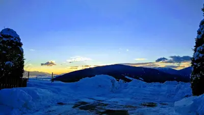 a pile of snow with a sunset in the background at Residence Condor in Maranza