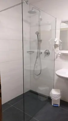 a bathroom with a shower and a toilet and a sink at Residence Condor in Maranza