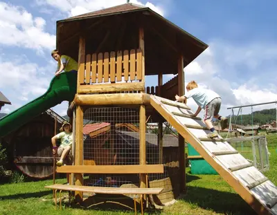 a group of children playing on a playground at Residence Condor in Maranza