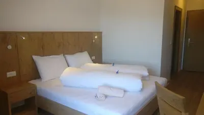 a white bed with two pillows on top of it at Residence Condor in Maranza