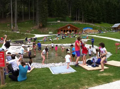 a group of people playing in the water at a park at Casa Vacanze Villa Elena in Alleghe