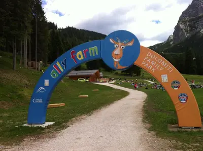 a sign for a farm with a cow on a road at Casa Vacanze Villa Elena in Alleghe