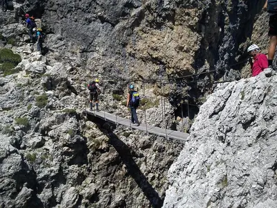 a group of people walking on a bridge on a mountain at Casa Vacanze Villa Elena in Alleghe