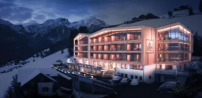 a bedroom with a bed and a television in it at Kronplatz-Resort Berghotel Zirm in Valdaora