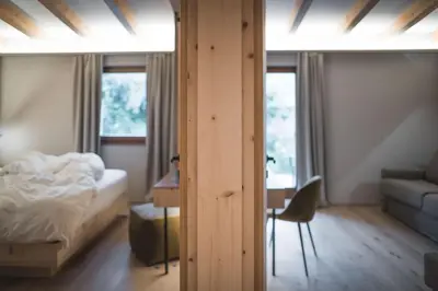 a man sitting on a bunk bed in a boat at Kronplatz-Resort Berghotel Zirm in Valdaora