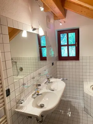 a white bathroom with a sink and a mirror at Im weißen Schlössl Friedemann in Rasùn di Sotto