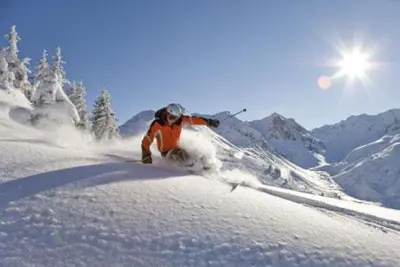 a person is skiing down a snow covered slope at Im weißen Schlössl Friedemann in Rasùn di Sotto