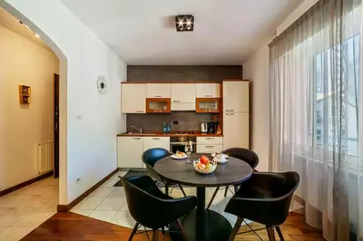 a kitchen with a table and chairs in a room at Appartements König in Merano