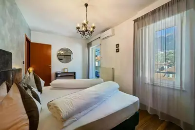 a bedroom with two beds and a window at Appartements König in Merano