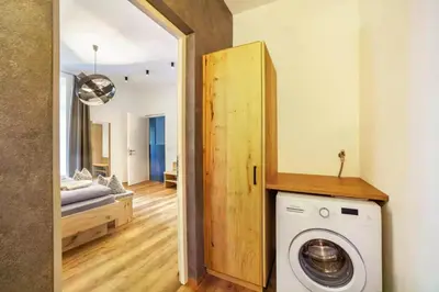 a laundry room with a washer and dryer in a house at Appartements König in Merano