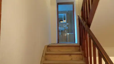 a staircase with a glass door leading to a bathroom at Appartamento Lidia Astor in Alleghe