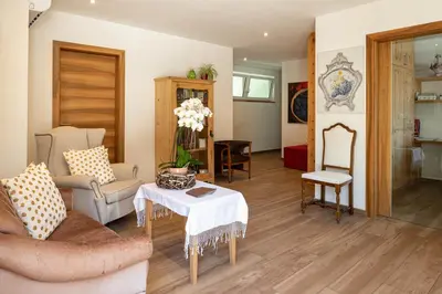 a living room with a couch and a table at Landhaus am Gries in Lana