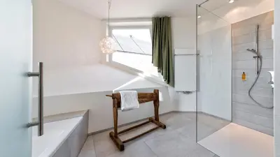 a bathroom with a tub and a shower and a window at Niedermairhof in Brunico
