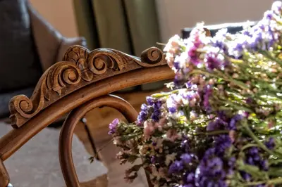 a mirror with a bunch of purple flowers at Niedermairhof in Brunico