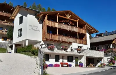 a large white building with a balcony at Chalet Apartments Ambria in La Villa