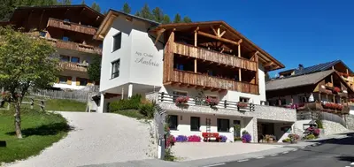 a large white building with a balcony at Chalet Apartments Ambria in La Villa