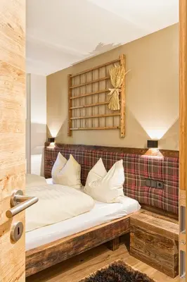 a bedroom with a bed in a room at Chalet Da Mont in Selva di Val Gardena