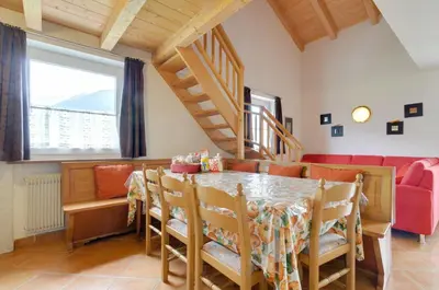 a dining room with a table and chairs at Roe Apartment in Panchia