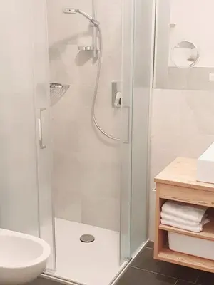 a bathroom with a shower and a toilet and a sink at Residence Majarai in Colfosco