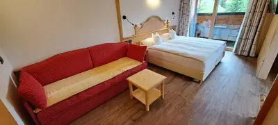 a bedroom with a bed with a blue comforter at La Campagnola in Canazei