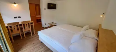 a bedroom with a bed with a heart on the wall at La Campagnola in Canazei