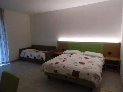 a bedroom with two beds in a room at Garni Festil in Campitello di Fassa