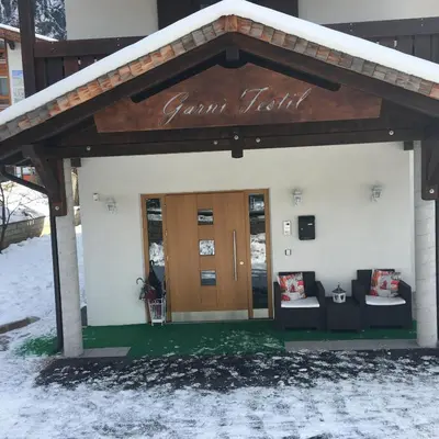 a building with a sign that reads german folk at Garni Festil in Campitello di Fassa