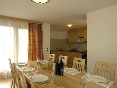 a dining room with a table with plates and glasses at Chalet Susi in La Villa