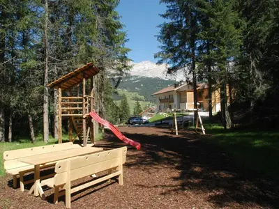 a park with a playground with a swing set at Chalet Susi in La Villa