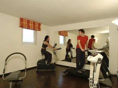 a group of people in a gym on exercise bikes at Chalet Susi in La Villa