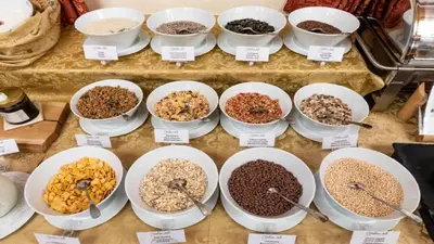 a display of bowls of different types of cereal at Cityhotel Goldener Adler B&B in Chiusa