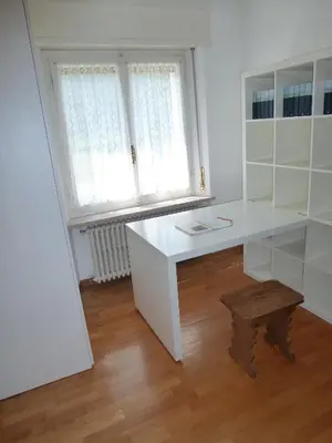a white desk in a room with a window at Appartamento Sole in Borca di Cadore