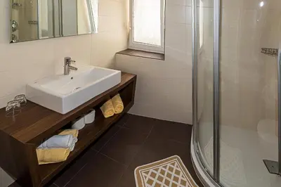 a bathroom with a sink and a shower at Garni Hotel Dorothea in Tirolo
